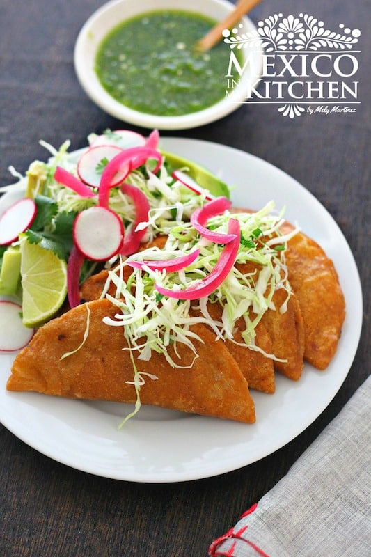 Tuna empanadas with radishes, cabbage and limes. 
