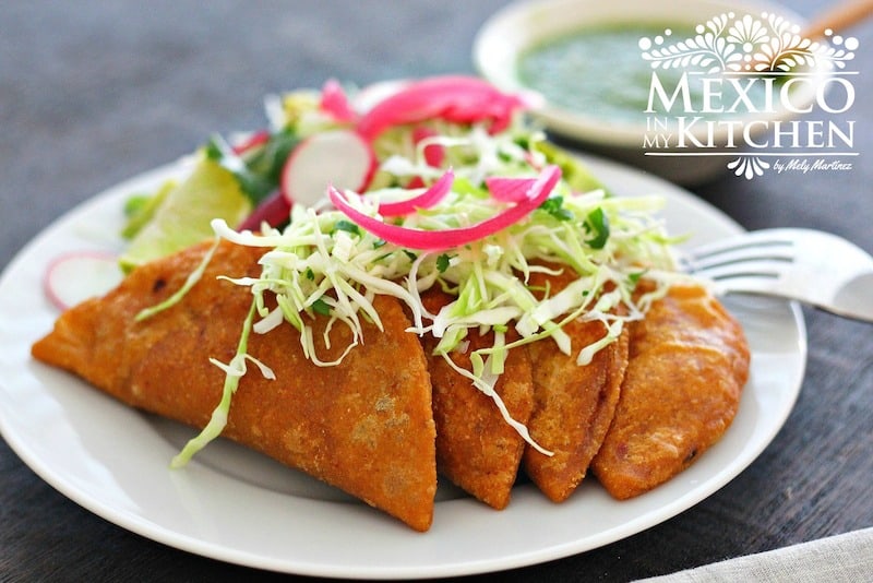 Mexican tuna empanadas with cabbage and pickled onions. 