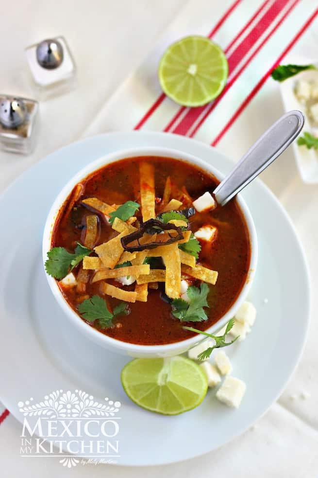 bowl of tortilla soup with tortilla strips and cilantro on top