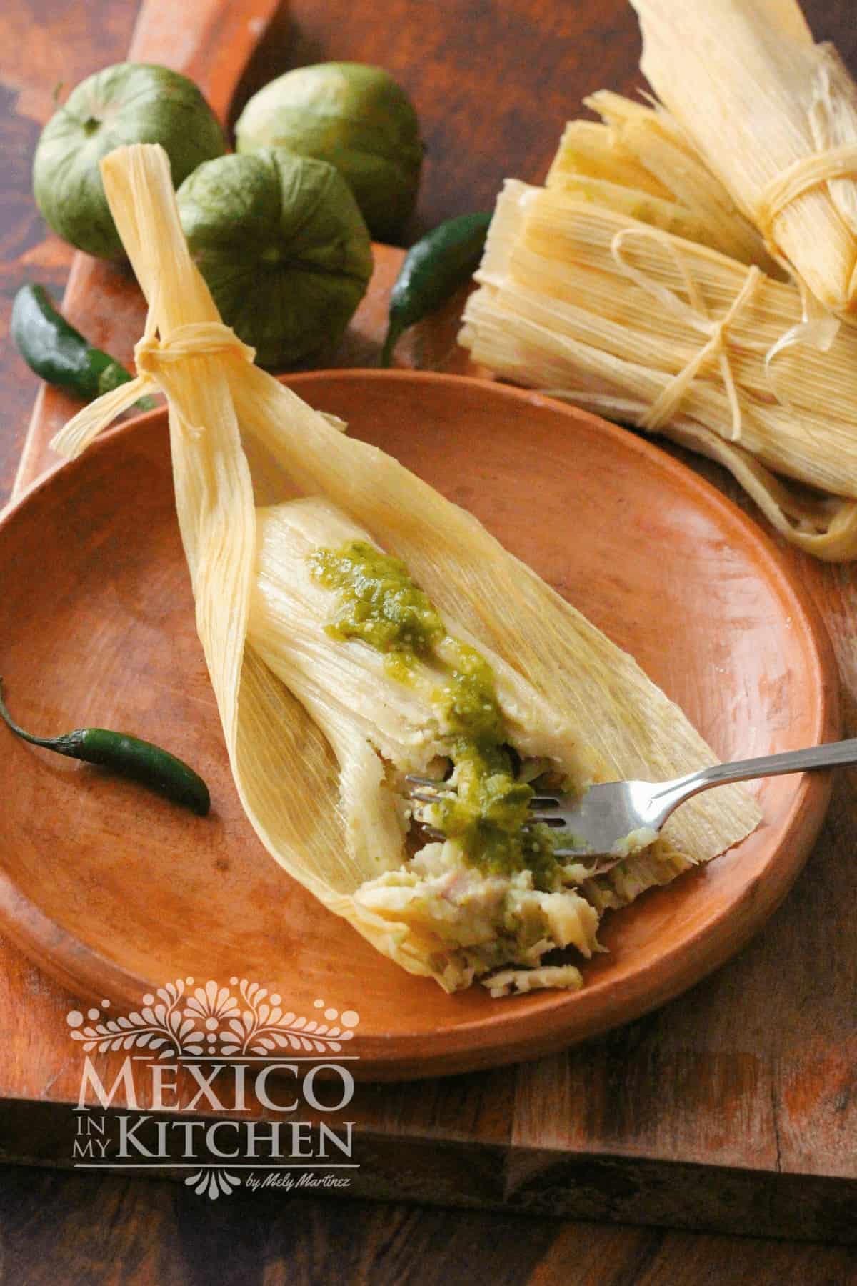 Chicken Tamales with Green Salsa over a clay platter