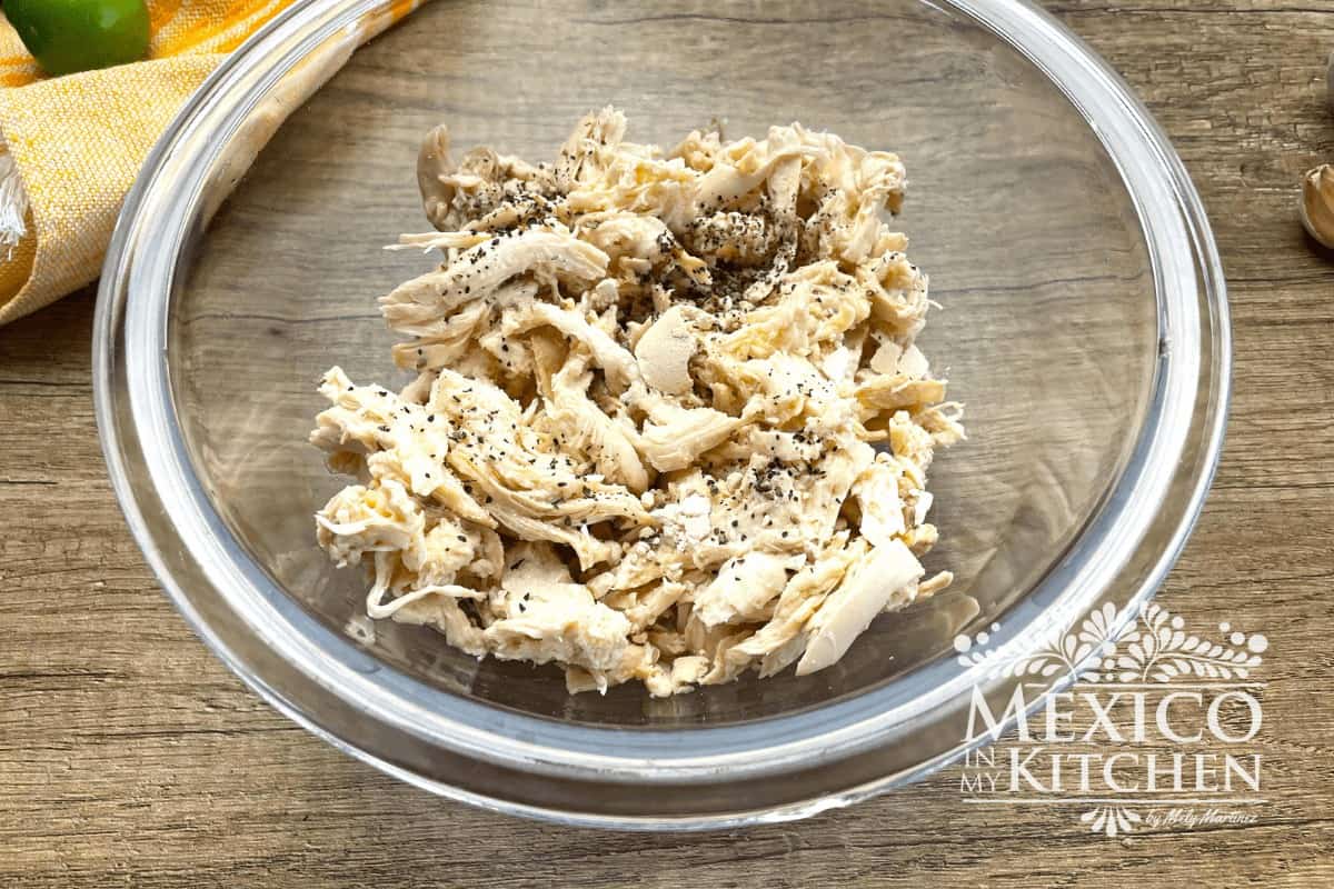 Seasoned and shredded chicken on a bowl.