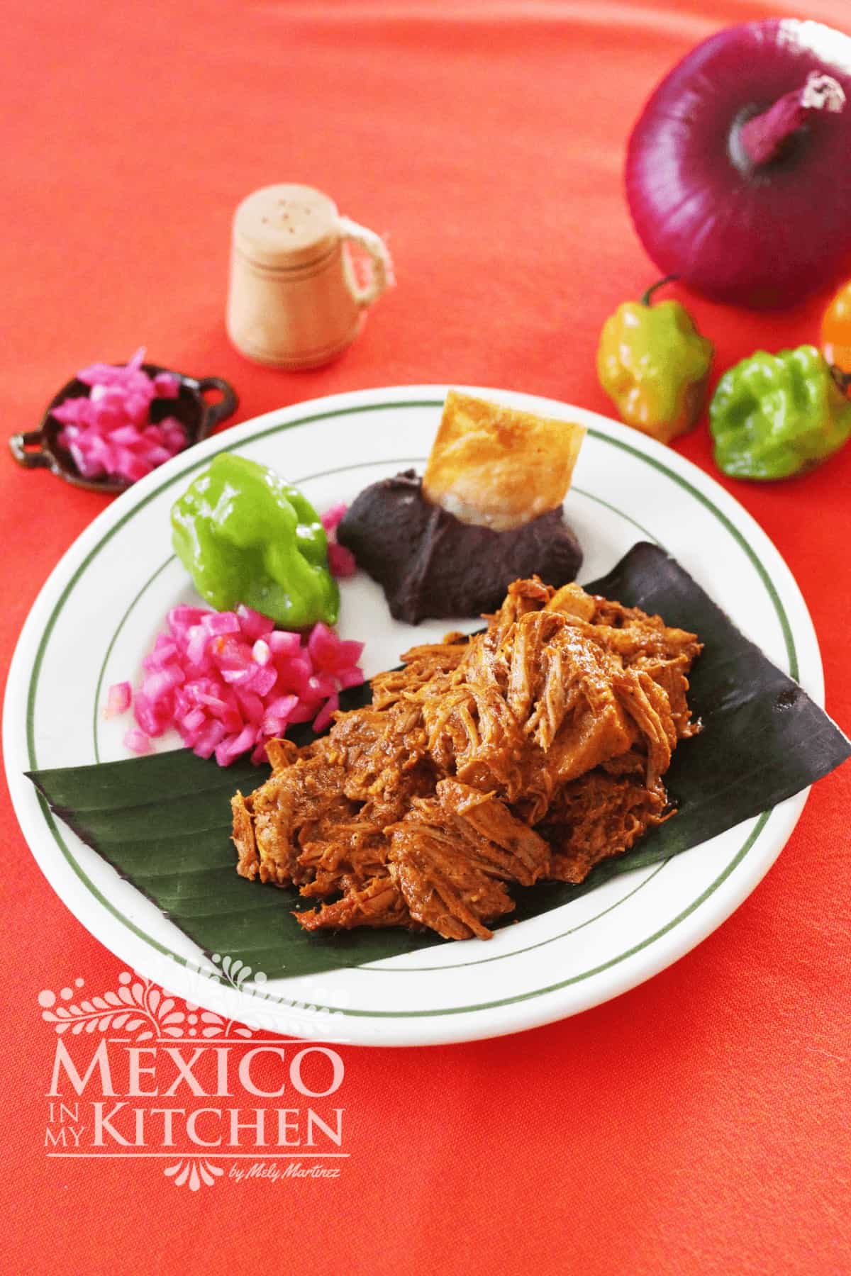 Cochinita on a banana leaf with pickled onions