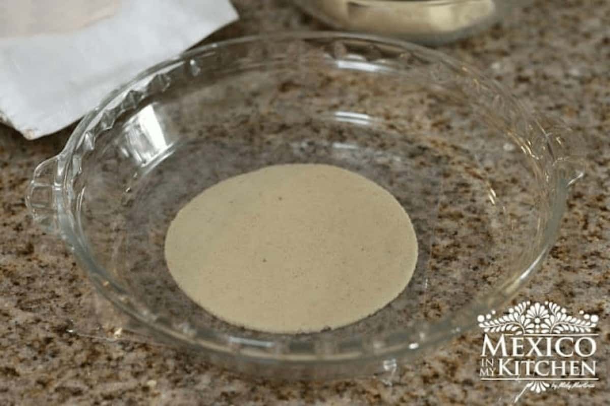 Pressing masa dough with a glass baking dish