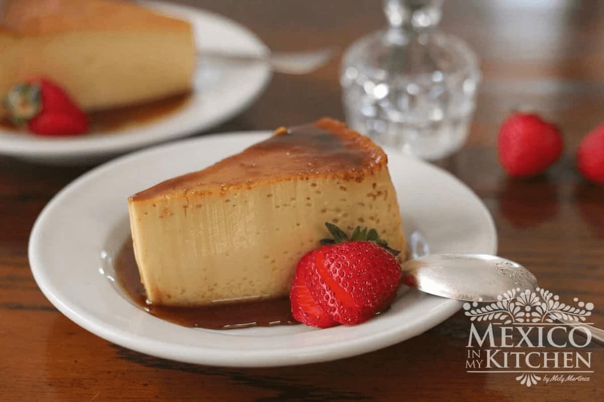 Easy Mexican flan served in a plate with strawberries