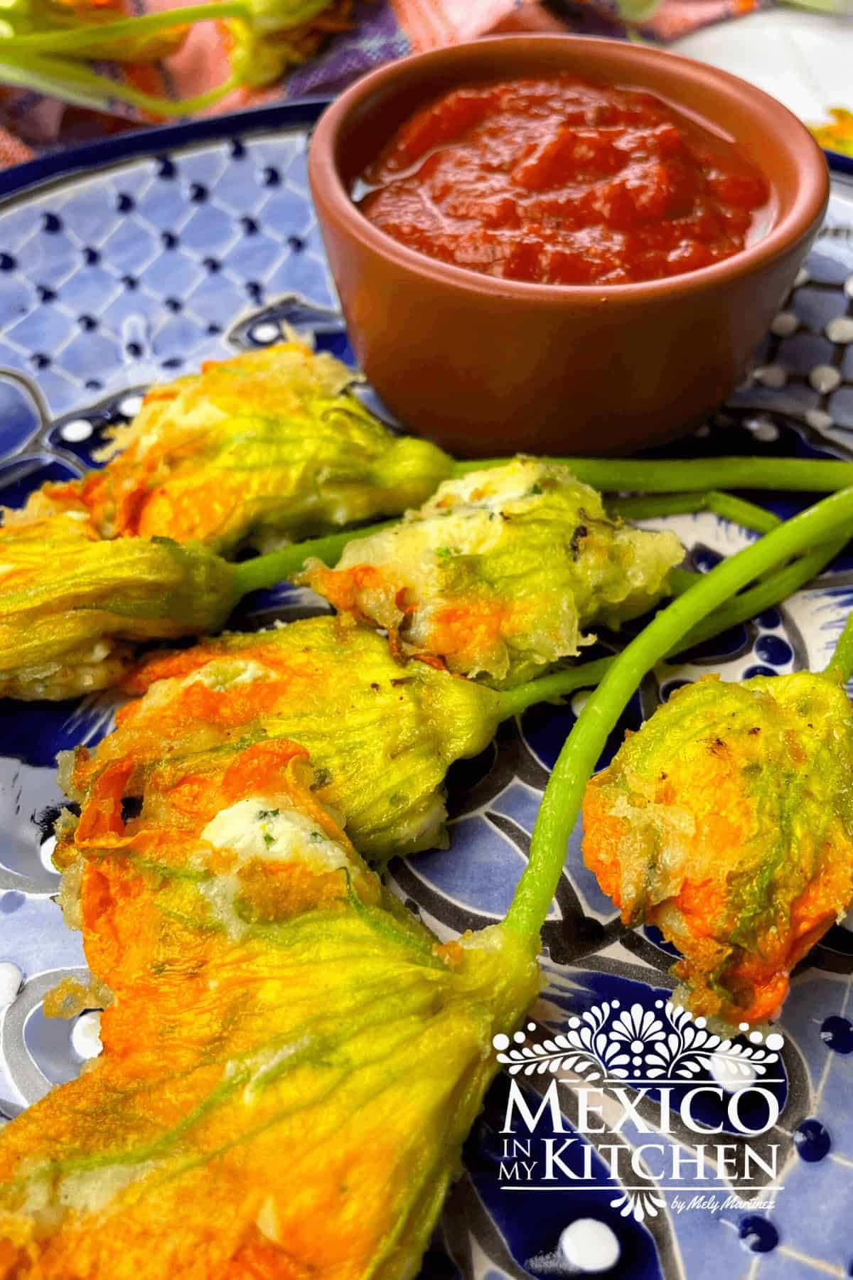 Fried and stuffed squash blossoms on a plate