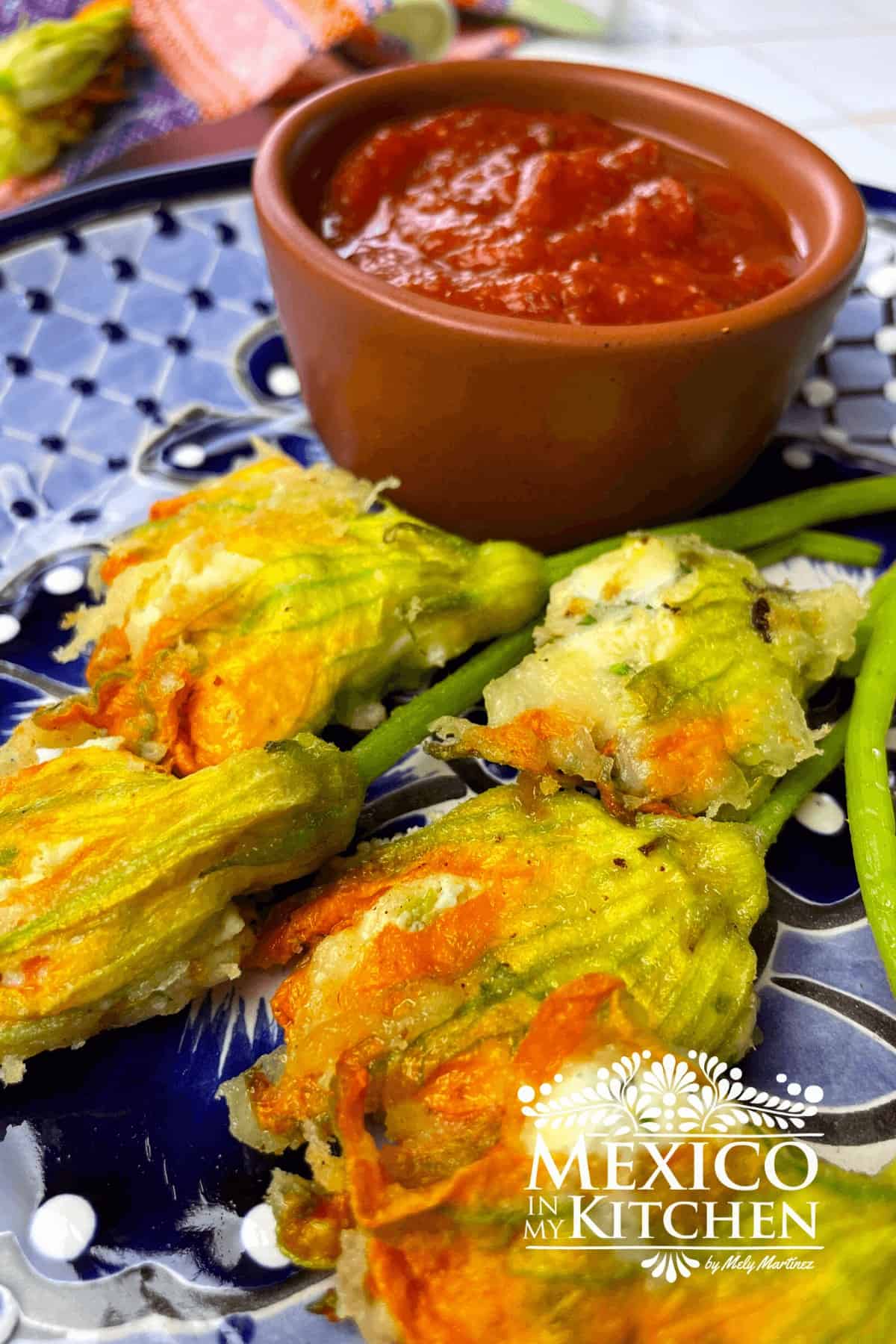 Stuffed blossoms on a plate with sauce