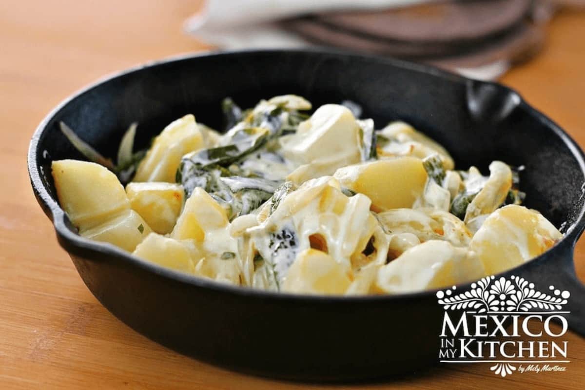 cast iron skillet with potatoes, poblanos and cream.