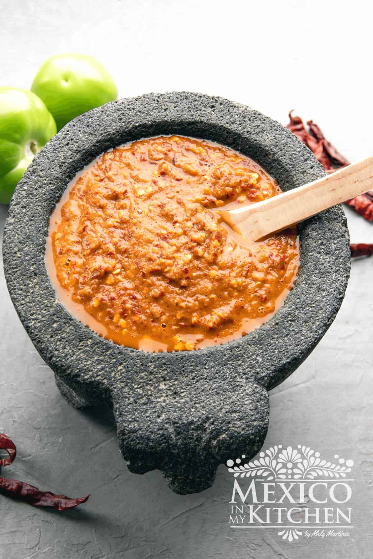 Roasted tomatillos and arbol pepper salsa in a molcajete