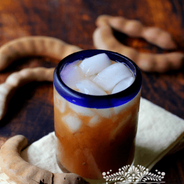 Agua de tamarindo (Tamarind drink) served in a glass with ice.