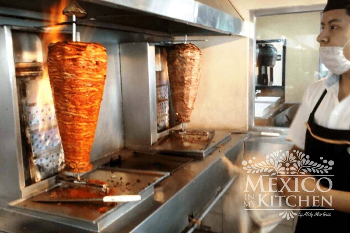 Mexican al pastor meat slow-cooked on a spinning spit roast.