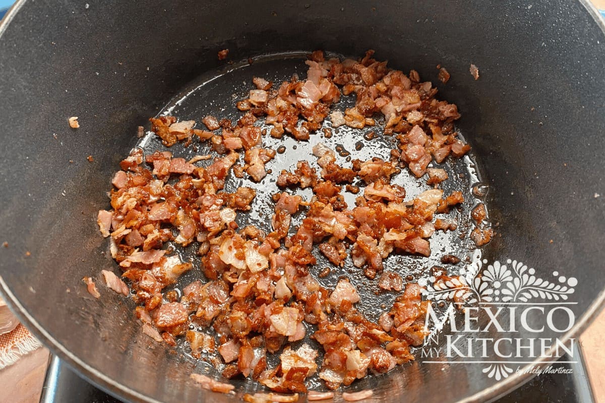 Bacon pieces been cook in a frying pan