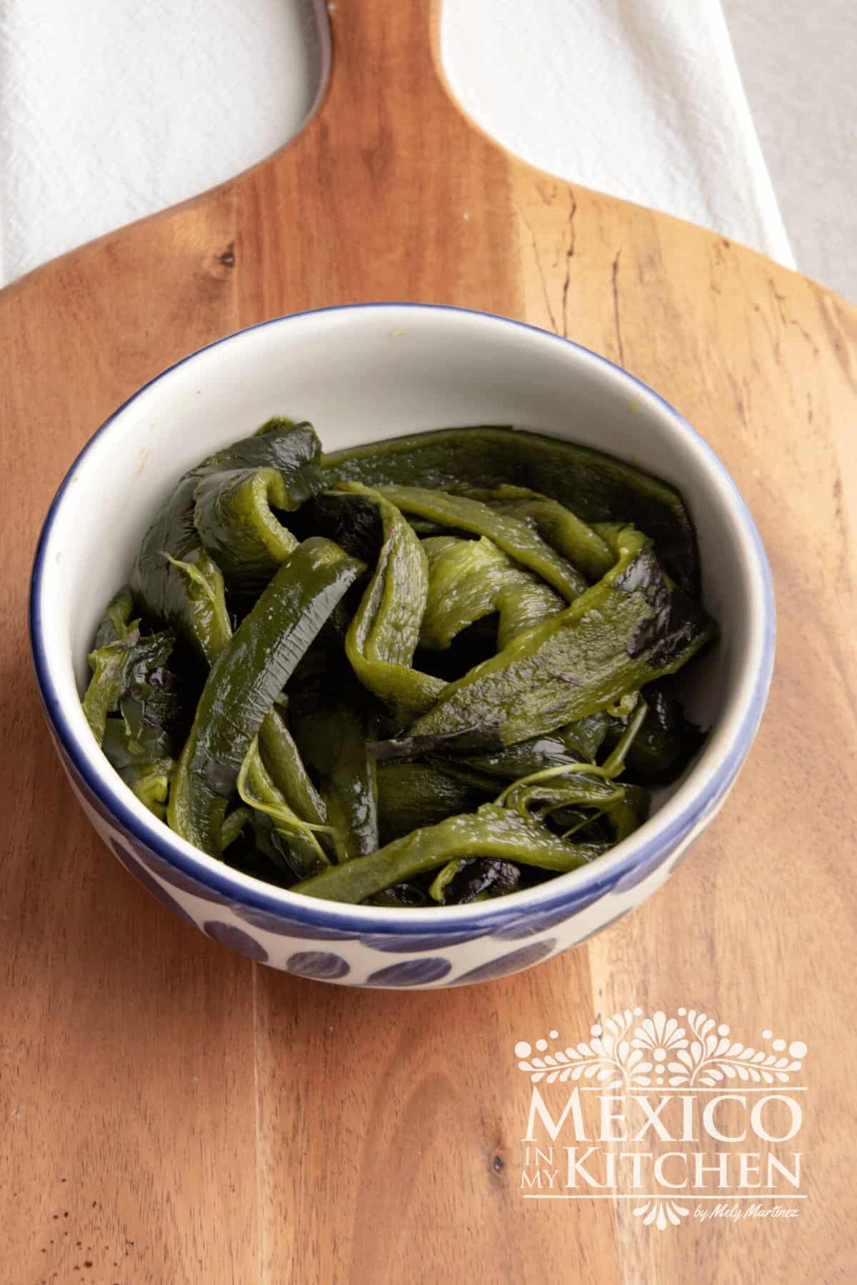 Roasted poblano peppers in a bowl.