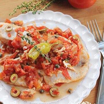 Tilapia Veracruz Style topped with capers, olives and tomato sauce.