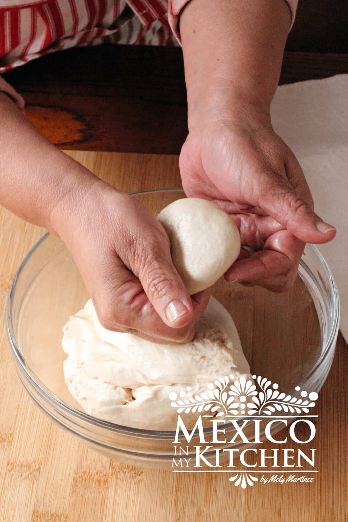 Making a small circular dough piece with your hands.