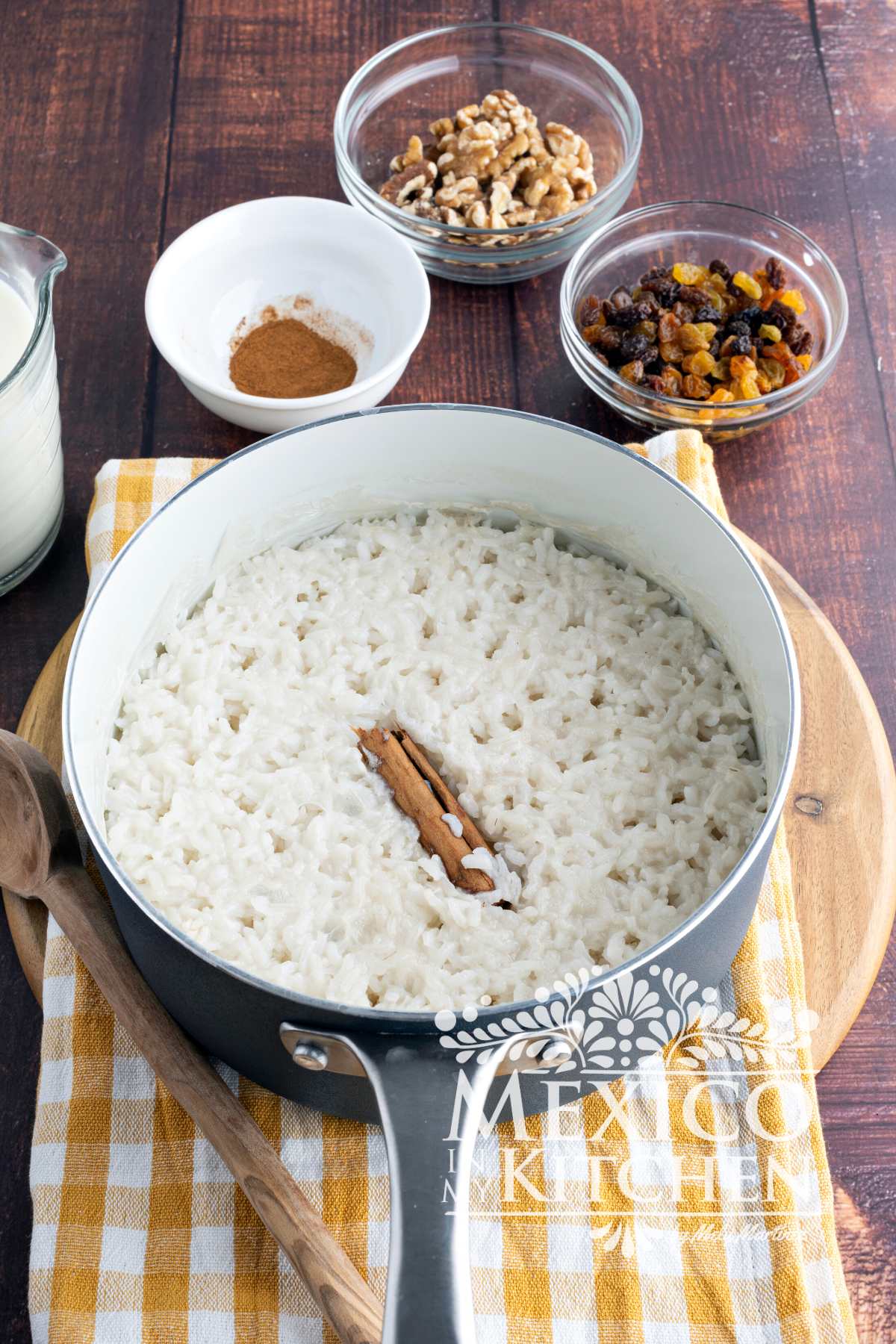 Cooked rice in a pot with a cinnamon stick.