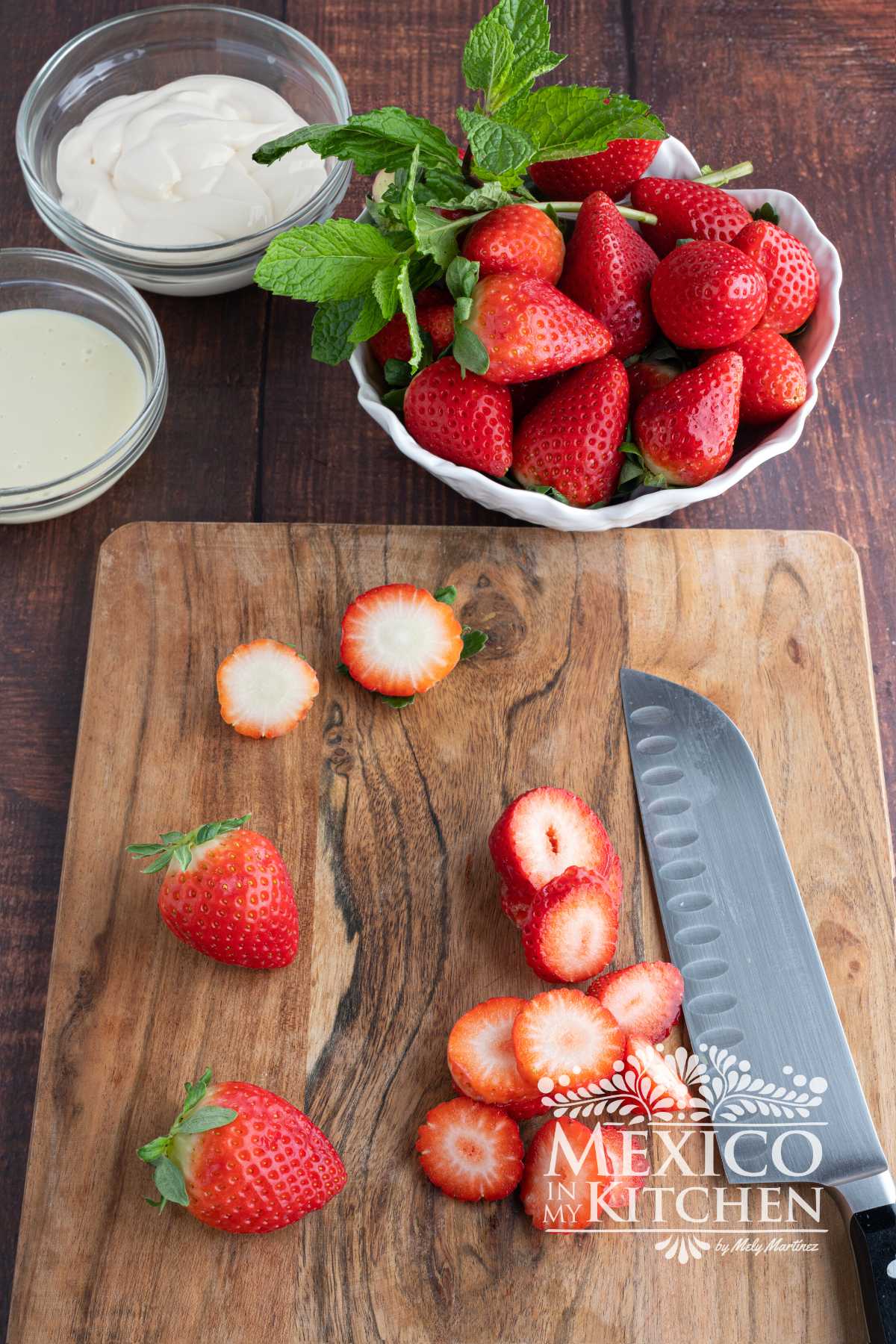 Thin slicing strawberries on a cutting board.