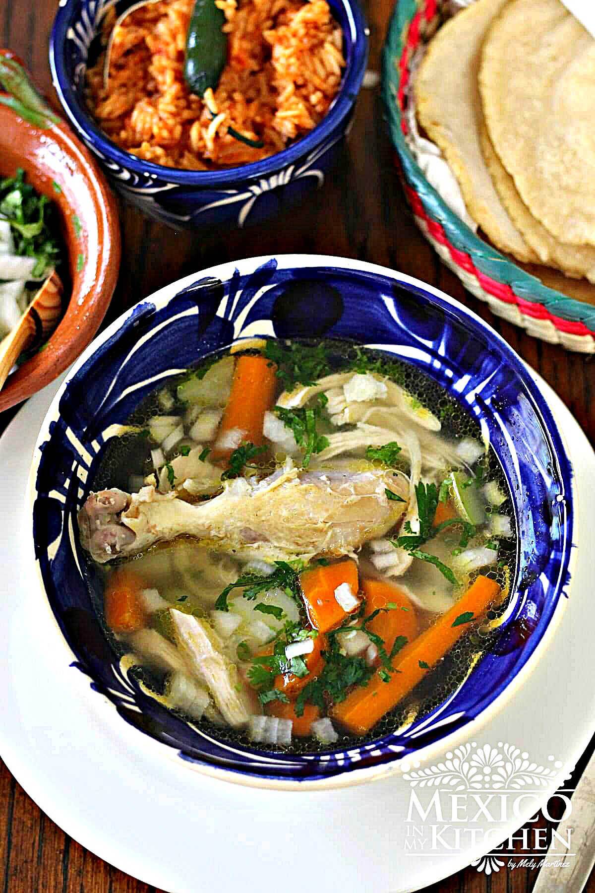 Mexican chicken soup, (caldo de pollo) served in a bowl.