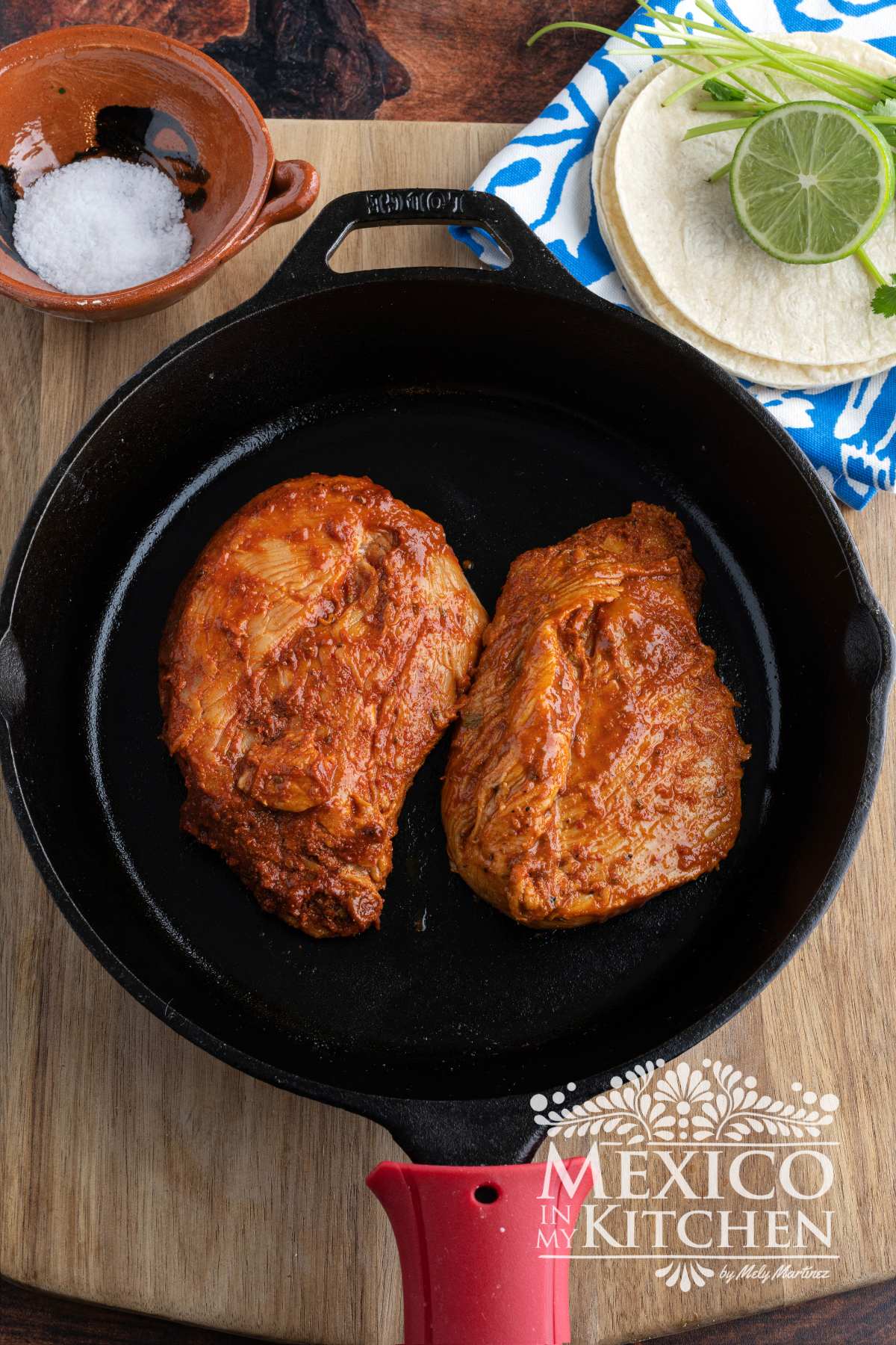 Marinated chicken in a cast iron pan.