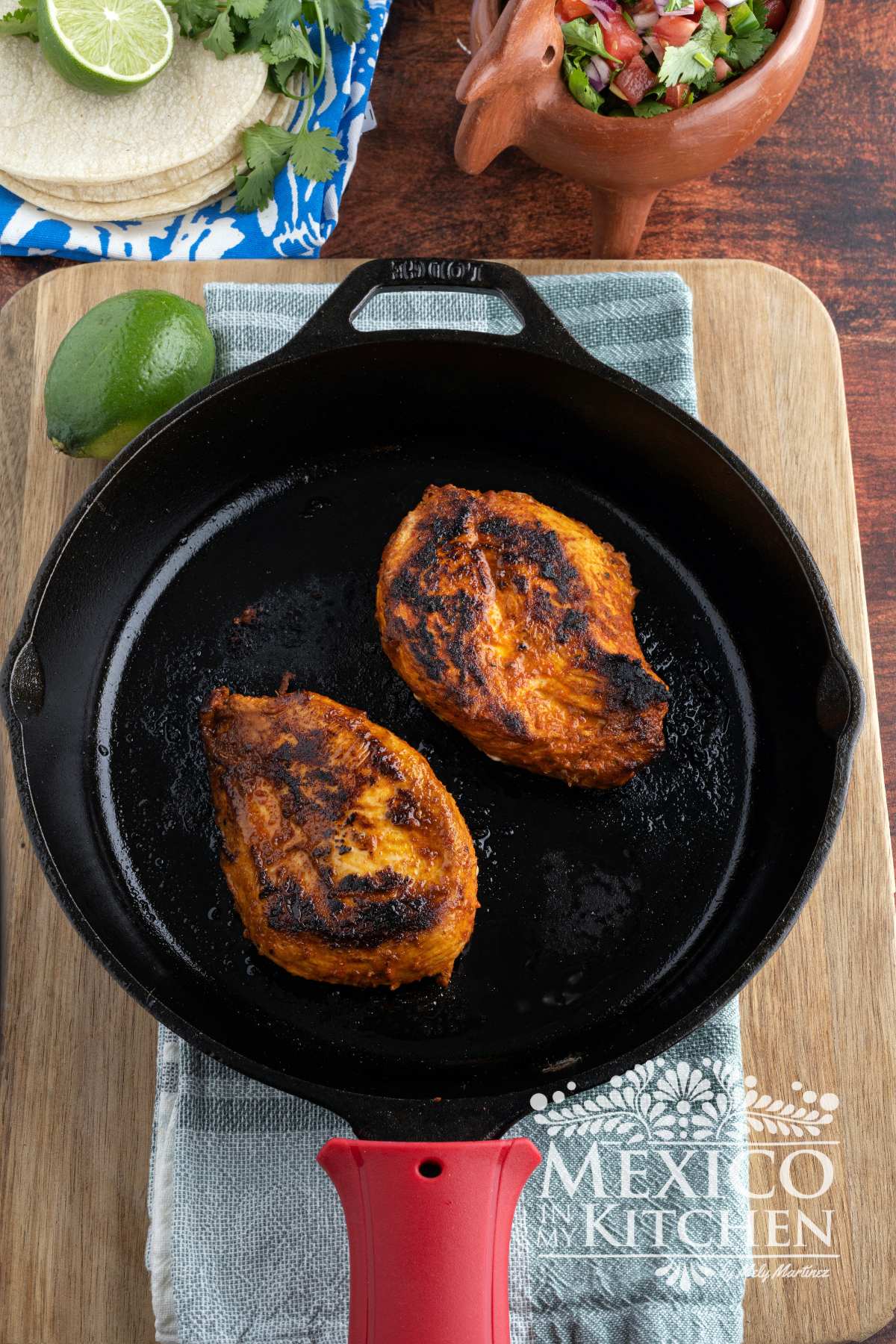 Grilled chicken in a cast iron pan.
