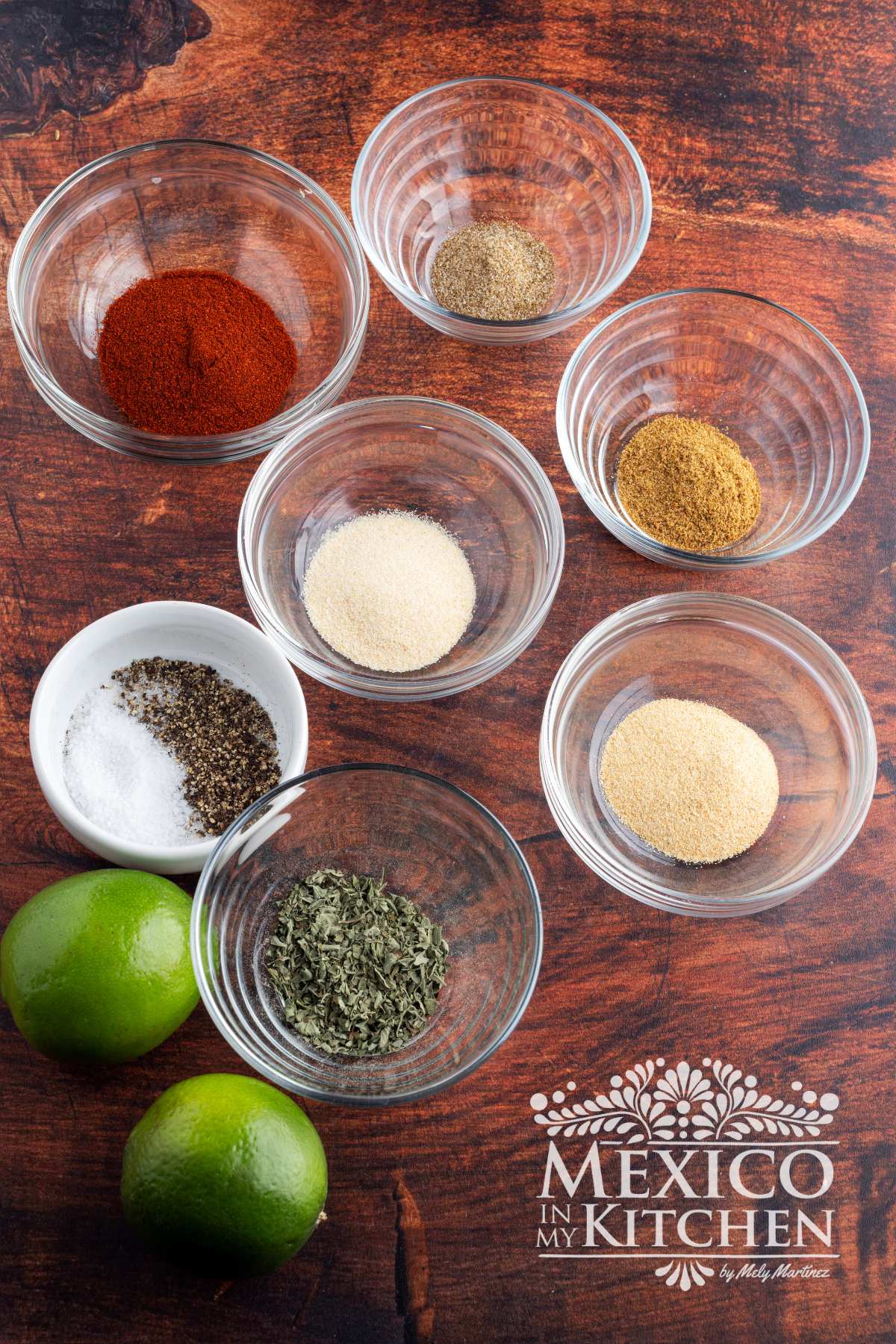 Spices in glass bowls on a countertop.