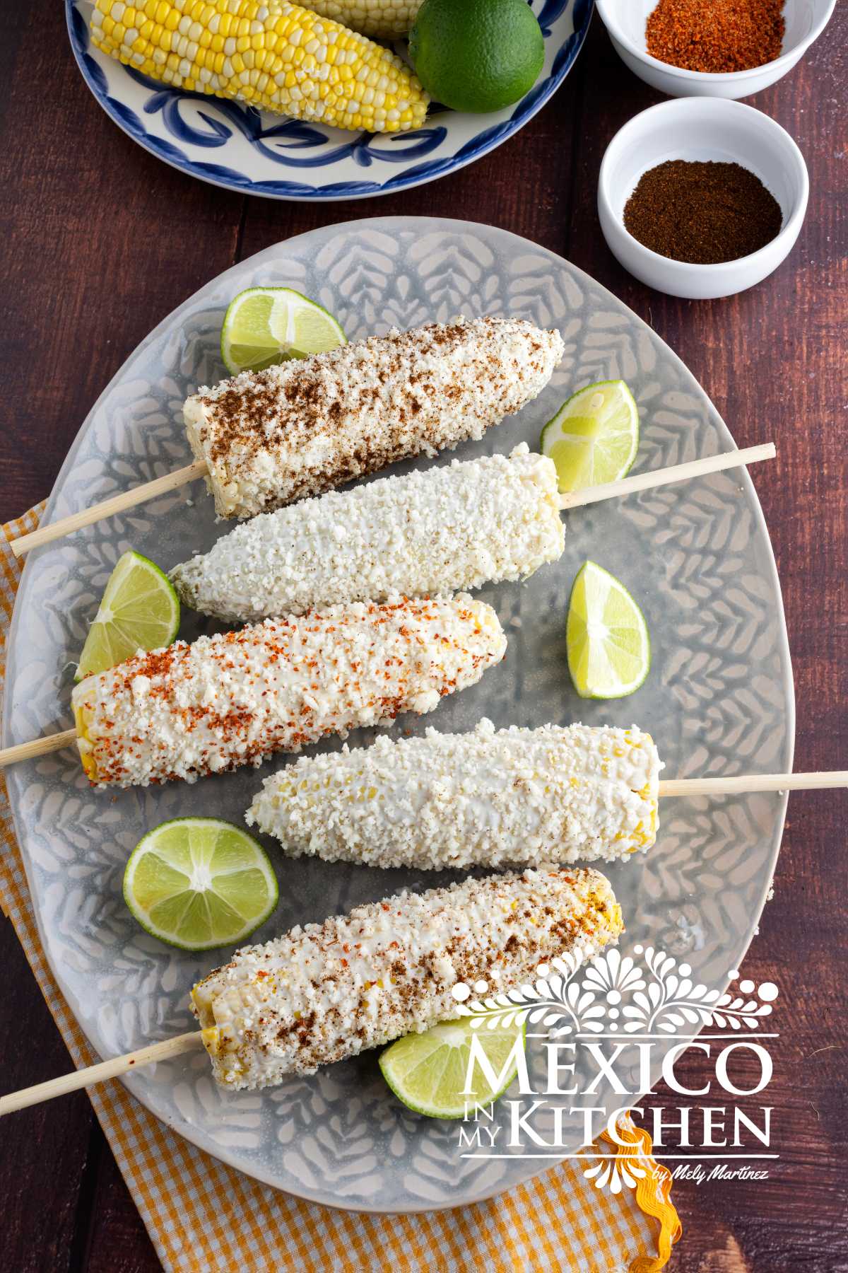 Mexican corn on the cob with different chili powder on a platter.