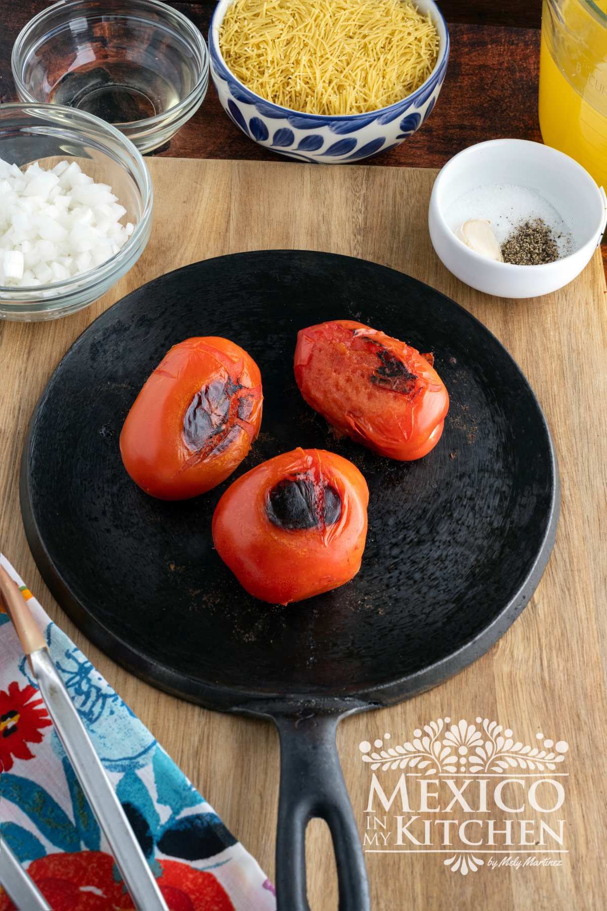 Roasted tomatoes in a cast iron pan.