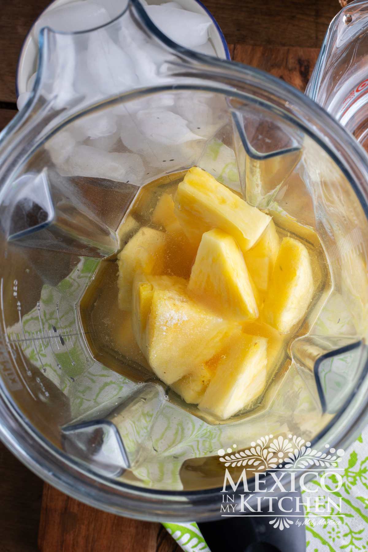 Blender with fresh pineapple, water and sugar.