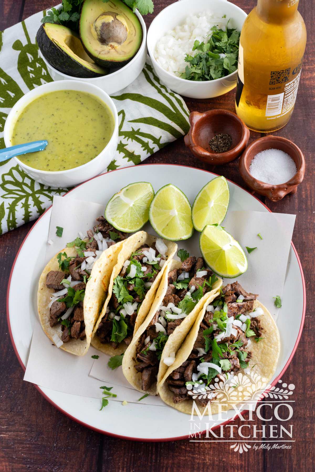 Steak Tacos served in corn tortillas and topped with cilantro and chopped onions.
