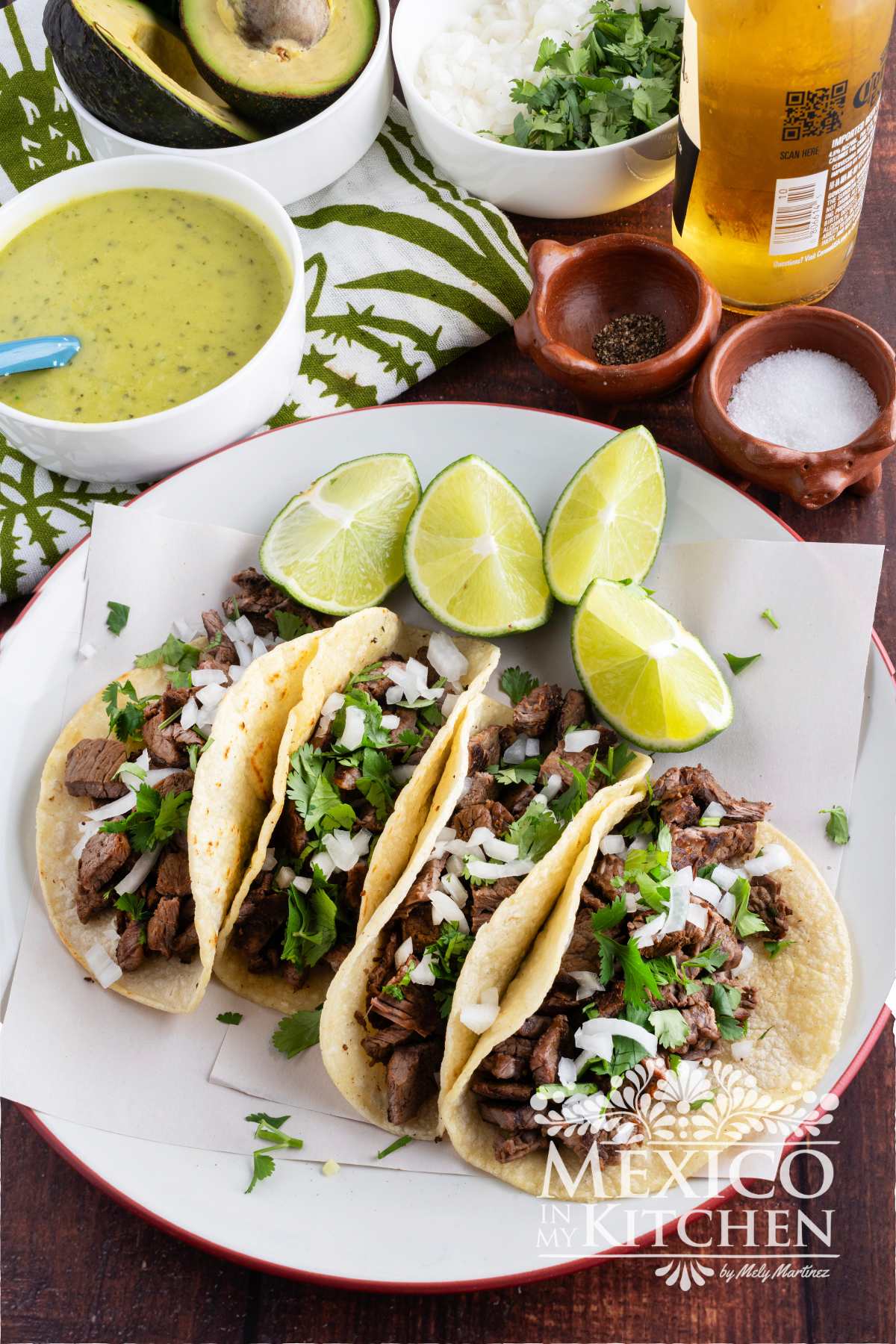 Steak Tacos served in corn tortillas and topped with cilantro and chopped onions.