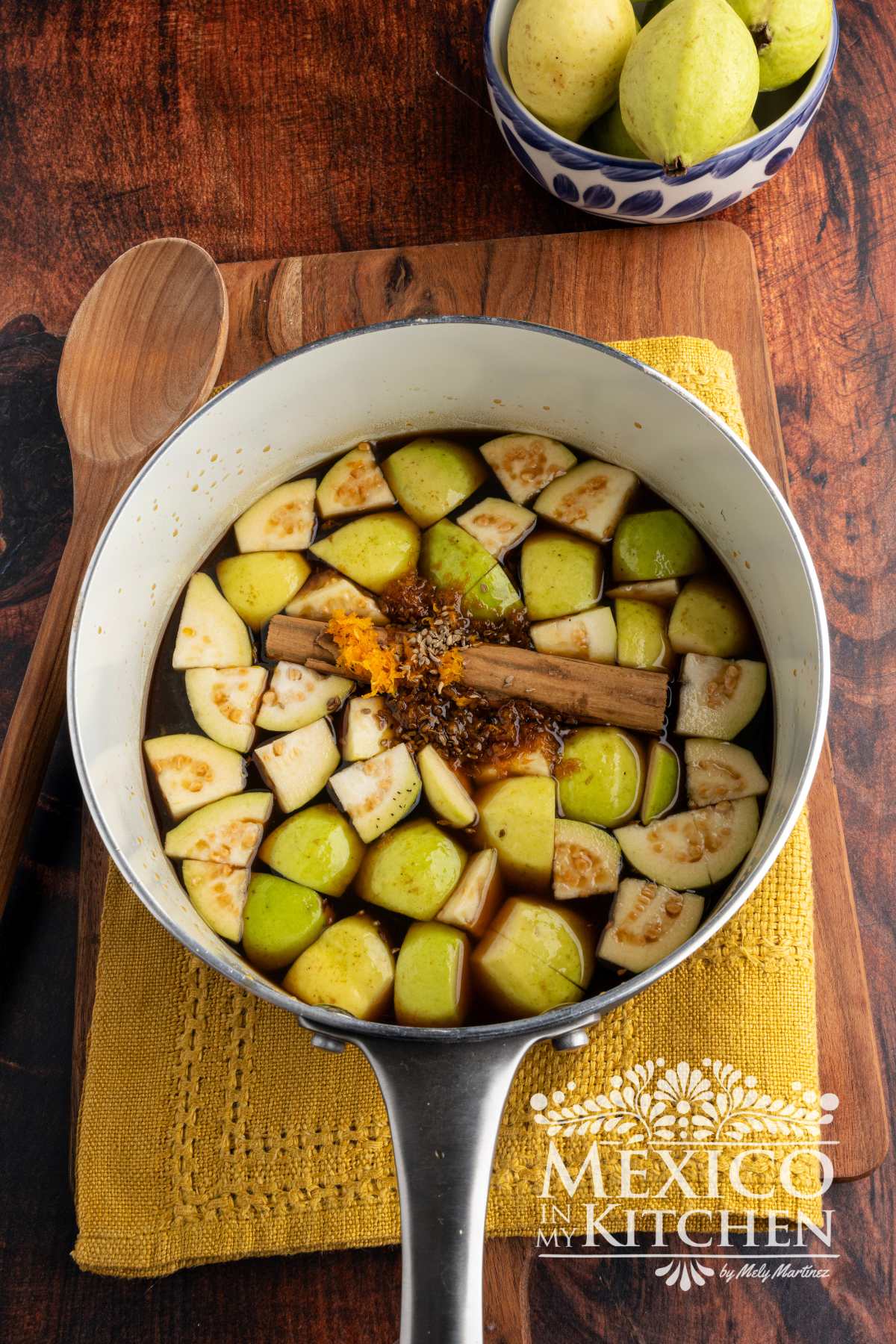 Piloncillo with guavas, cinnamon, anise seeds, and water in a sauce pot.