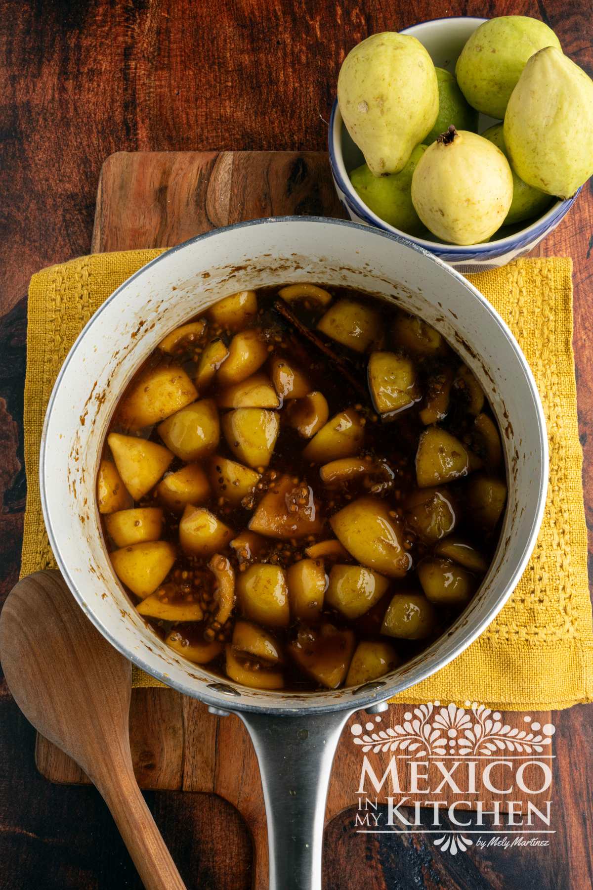 Piloncillo with guavas, cinnamon, anise seeds, and water in a sauce pot.