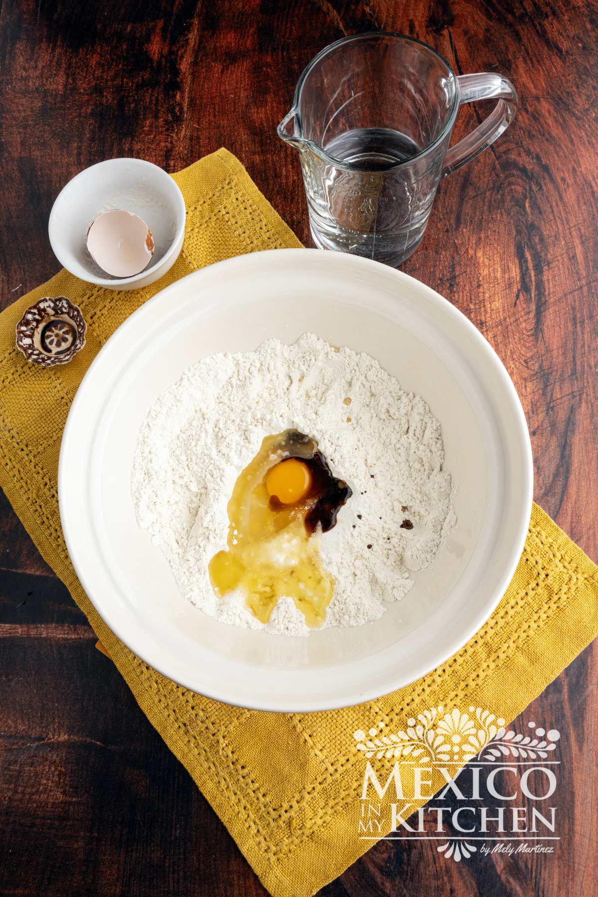 Flour, melted butter, an egg and vanilla in a mixing bowl.