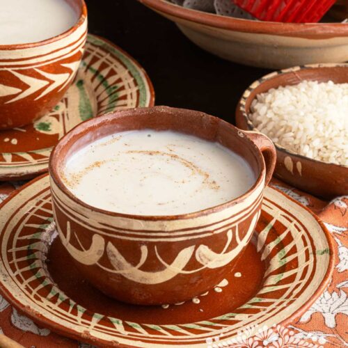 Rice Atole (mexican Atole de Arroz) served in red clay mugs .