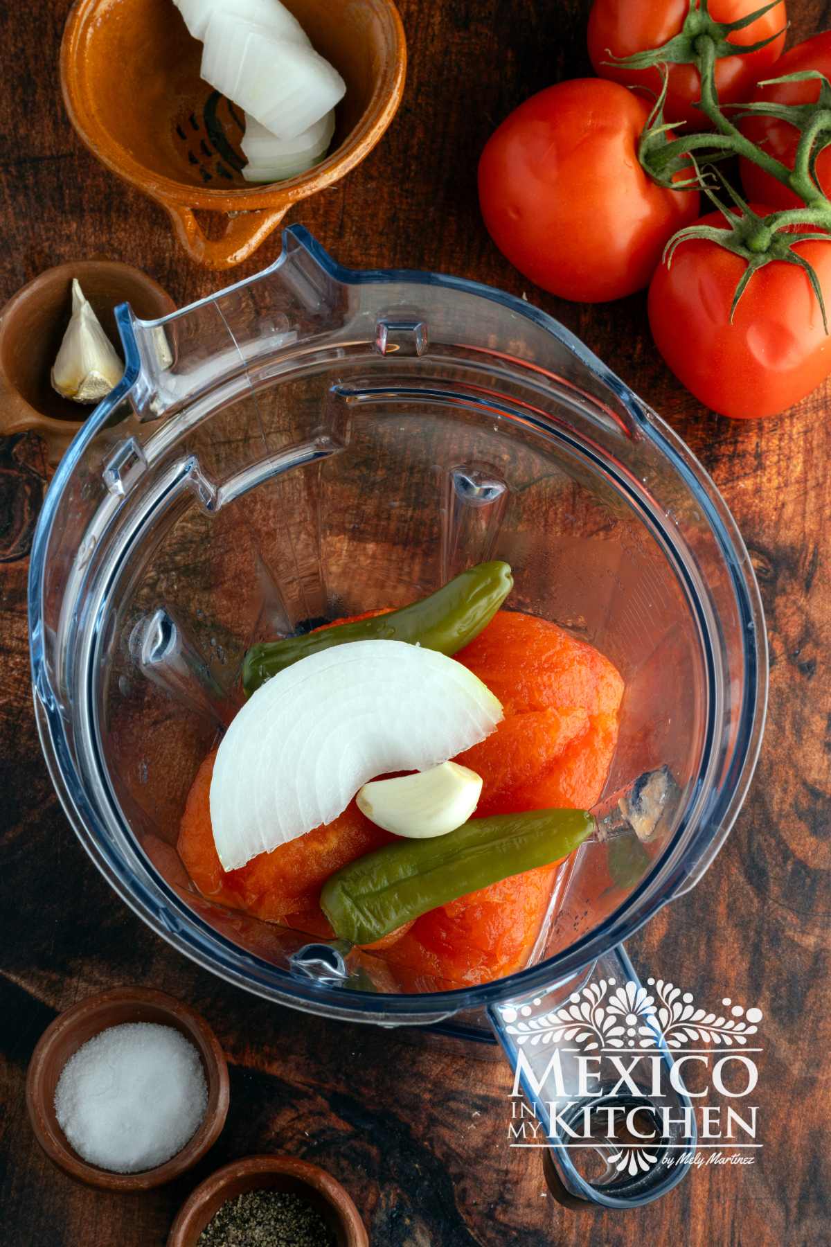 Cooked tomatoes, and serranos in blender.