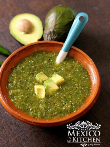 Roasted Tomatillo Salsa serve in a clay bowl.