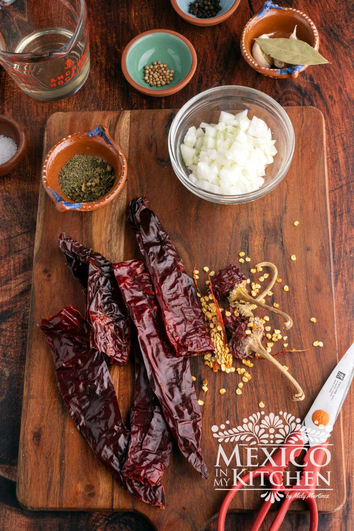 Guajillo peppers cleaned and deveined in a cutting board.