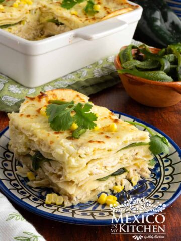Pastel Azteca slice topped with fresh cilantro and corn.