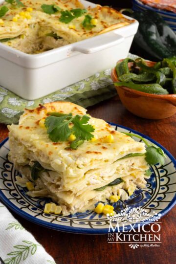 Pastel Azteca slice topped with fresh cilantro and corn.
